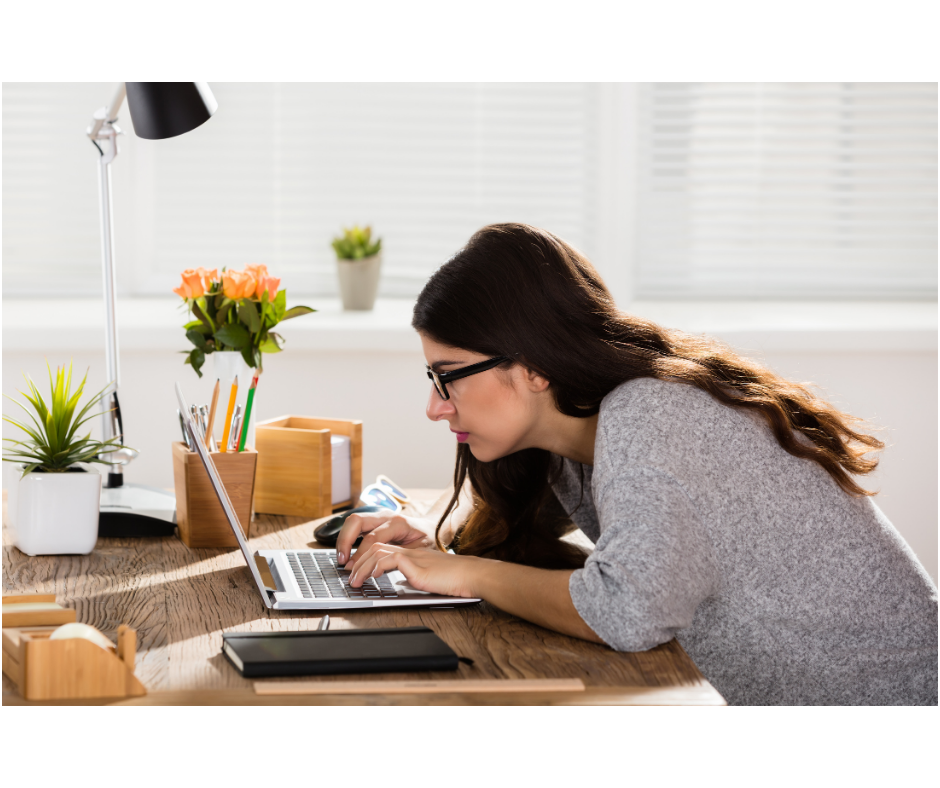 Woman slumped working at laptop showing poor posture to illustrate DSE assessment articel