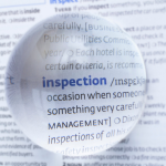 Magnified word inspection to illustrate article What is the difference between a Workplace Inspection and Health and Safety Audit?